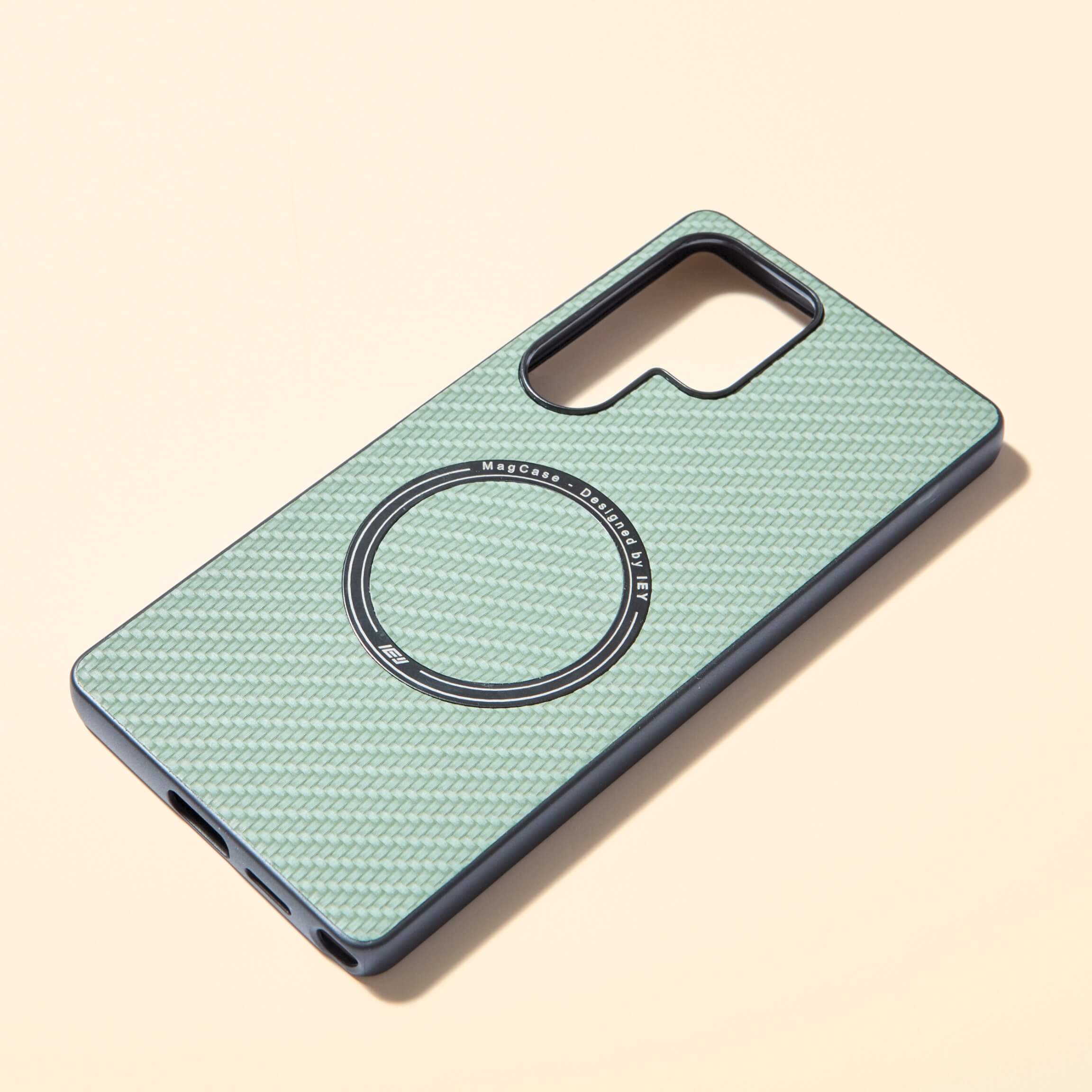 Funda MagSafe verde con textura tipo fibra de carbono, vista frontal con aro imantado grabado y diseño ultraligero #color_verde